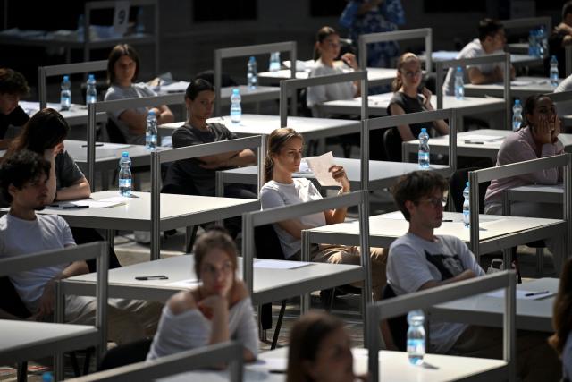 CORRECTION / A student uses a piece of paper to cool off as students prepare to take university entrance exams at the Belgrade Fair in Belgrade on June 25, 2026, as Serbia endures a heatwave affecting much of southeastern and central Europe. At least 101 million Europeans were expected to experience temperatures of over 35C on June 25, 2026, in a punishing and increasingly deadly heatwave hotter than weather in parts of Africa. (Photo by OLIVER BUNIC / str / AFP) / The erroneous mention[s] appearing in the metadata of this photo by OLIVER BUNIC has been modified in AFP systems in the following manner: [June 25] instead of [June 29]. Please immediately remove the erroneous mention[s] from all your online services and delete it (them) from your servers. If you have been authorized by AFP to distribute it (them) to third parties, please ensure that the same actions are carried out by them. Failure to promptly comply with these instructions will entail liability on your part for any continued or post notification usage. Therefore we thank you very much for all your attention and prompt action. We are sorry for the inconvenience this notification may cause and remain at your disposal for any further information you may require.