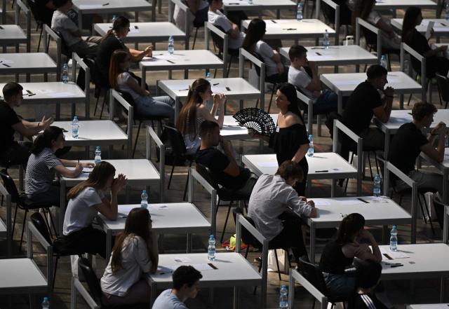 CORRECTION / A professor uses a hand fan to cool off as students prepare to take university entrance exams at the Belgrade Fair in Belgrade on June 25, 2026, as Serbia endures a heatwave affecting much of southeastern and central Europe. At least 101 million Europeans were expected to experience temperatures of over 35C on June 25, 2026, in a punishing and increasingly deadly heatwave hotter than weather in parts of Africa. (Photo by OLIVER BUNIC / str / AFP) / The erroneous mention[s] appearing in the metadata of this photo by OLIVER BUNIC has been modified in AFP systems in the following manner: [June 25] instead of [June 29]. Please immediately remove the erroneous mention[s] from all your online services and delete it (them) from your servers. If you have been authorized by AFP to distribute it (them) to third parties, please ensure that the same actions are carried out by them. Failure to promptly comply with these instructions will entail liability on your part for any continued or post notification usage. Therefore we thank you very much for all your attention and prompt action. We are sorry for the inconvenience this notification may cause and remain at your disposal for any further information you may require.