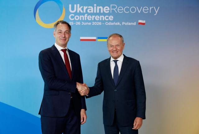 Polish Prime Minister Donald Tusk (R) welcomes the Administrator of the United Nations Development Programme (UNDP) Alexander De Croo as he arrives to attend the Ukraine Recovery Conference (URC 2026) in Gdansk, Poland, on June 25, 2026. The Ukraine Recovery Conference (URC 2026), co-hosted by Poland and Ukraine, takes place in Gdansk on June 25–26, 2026, aiming to strengthen support for Ukraine’s reconstruction and boost investment, with a focus on energy, critical infrastructure, and logistics sectors. (Photo by Wojtek RADWANSKI / AFP)