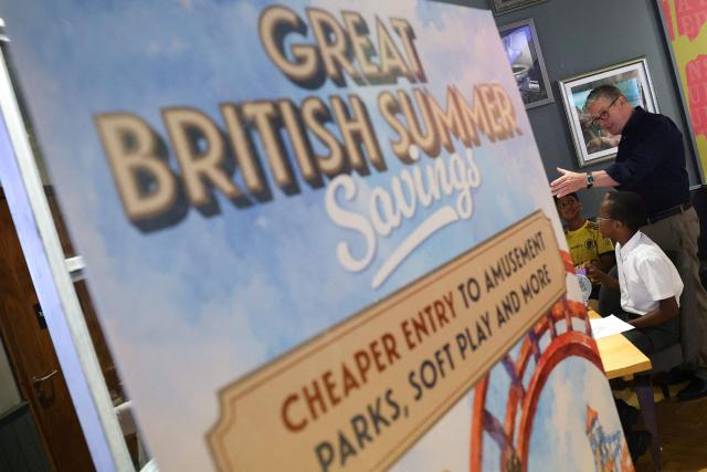 Britain's outgoing Prime Minister Keir Starmer (R) speaks with pupils from Summerfield Primary School as he promotes the official launch of the Great British Summer Savings scheme, at Odeon Milton Keynes Stadium cinema in Milton Keynes, north of London on June 25, 2026. (Photo by Toby Melville / POOL / AFP)