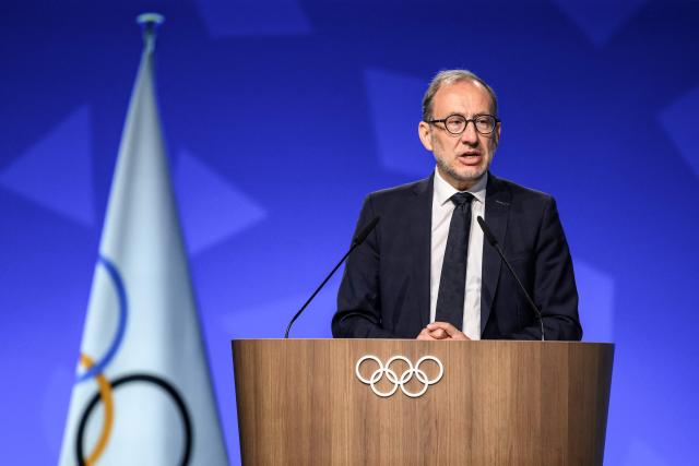 Director of the Organising Committee for the Alpes 2030 Winter Olympics Vincent Roberti speaks during an extraordinary session of the International Olympic Committee (IOC) in Lausanne on June 25, 2026. The roughly 100 members of IOC approved on June 25, 2026 the re-inclusion of ski mountaineering in the program for the Alpes 2030 Olympic Winter Games, which will take place in the French Alps, after the "additional sport" made its Olympic debut at Milan-Cortina in 2026. (Photo by Fabrice COFFRINI / AFP)