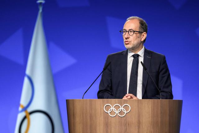 Director of the Organising Committee for the Alpes 2030 Winter Olympics Vincent Roberti speaks during an extraordinary session of the International Olympic Committee (IOC) in Lausanne on June 25, 2026. The roughly 100 members of IOC approved on June 25, 2026 the re-inclusion of ski mountaineering in the program for the Alpes 2030 Olympic Winter Games, which will take place in the French Alps, after the "additional sport" made its Olympic debut at Milan-Cortina in 2026. (Photo by Fabrice COFFRINI / AFP)