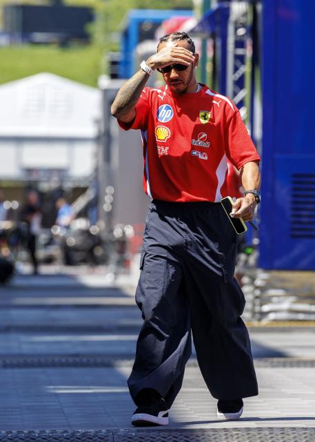 Ferrari's British driver Lewis Hamilton walks at the Red Bull Ring race track in Spielberg, Austria on June 25, 2026, ahead of the Formula One Austrian Grand Prix. (Photo by ERWIN SCHERIAU / APA / AFP) / Austria OUT
