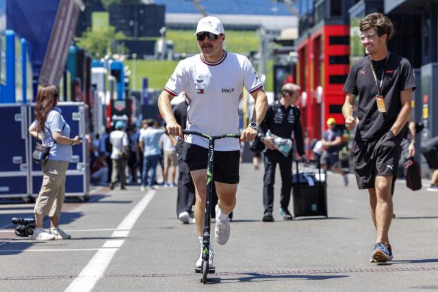 Cadillac's Finnish driver Valtteri Bottas arrives on an electric scooter at the Red Bull Ring race track in Spielberg, Austria on June 25, 2026, ahead of the Formula One Austrian Grand Prix. (Photo by ERWIN SCHERIAU / APA / AFP) / Austria OUT