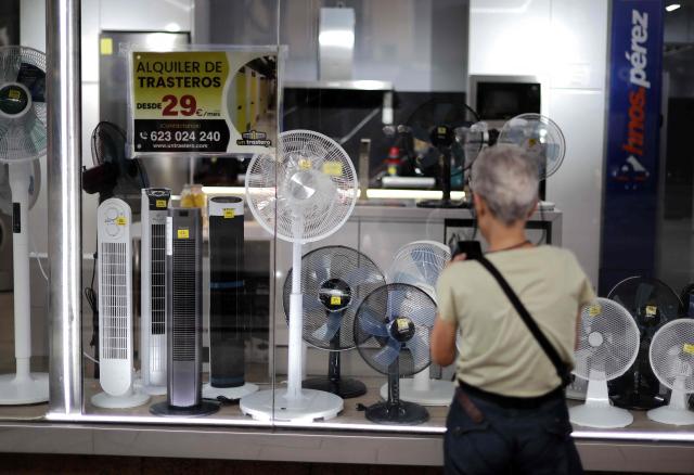 A woman looks at the window display of a shop selling fans during a heatwave in Madrid, on June 25, 2026. A recordheatwavethat has gripped much of Europe could be linked to 212 deaths in Spain between Sunday and Wednesday, according to estimates from a public institute. (Photo by Thomas COEX / AFP)