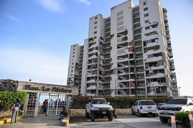 A general view shows apartments in a damaged building following an earthquake in Catia La Mar, La Guaira state, some 30km north-west of Caracas, on June 25, 2026. A twin earthquake that was Venezuela's largest in over a century has killed at least 164 people and destroyed multiple buildings near the capital, where residents searched on June 25 for missing relatives. (Photo by Federico PARRA / AFP)