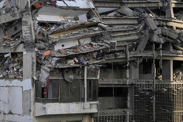 A general view shows apartments in a damaged building following an earthquake in Catia La Mar, La Guaira state, some 30km north-west of Caracas, on June 25, 2026. A twin earthquake that was Venezuela's largest in over a century has killed at least 164 people and destroyed multiple buildings near the capital, where residents searched on June 25 for missing relatives. (Photo by Federico PARRA / AFP)