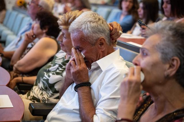 A relative of Dimitris Vafeiadis reacts during a ceremony for the return of personal belongings of Greek prisoners from Nazi forced labor camps to their families, held as part of the international StolenMemory campaign, at the Ministry of Foreign Affairs in Athens on June 25, 2026. (Photo by Angelos TZORTZINIS / AFP)