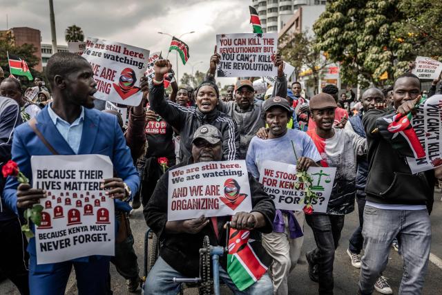 Protesters hold placards and chant anti-government slogans as they march during demonstrations marking the second anniversary of the deadly June 2024 youth-led anti-Finance Bill protests, which saw demonstrators storm Parliament, in Nairobi on June 25, 2026. Kenyan police put on a massive show of force on June 25 in a bid to prevent protests marking two years since a landmark Gen Z uprising. Thousands of Kenyans took to the streets in June 2024 against economic hardship and corruption, eventually storming parliament to force the cancellation of new taxes. (Photo by Luis TATO / AFP)