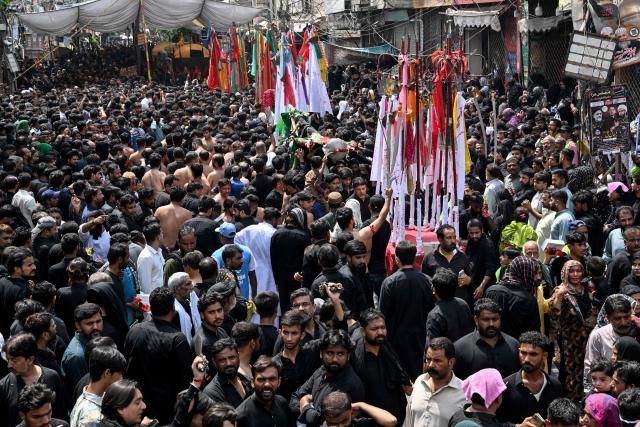 Shia Muslims take part in a religious procession on the ninth day of the Islamic holy month of Muharram in Lahore on June 25, 2026. (Photo by Arif ALI / AFP)