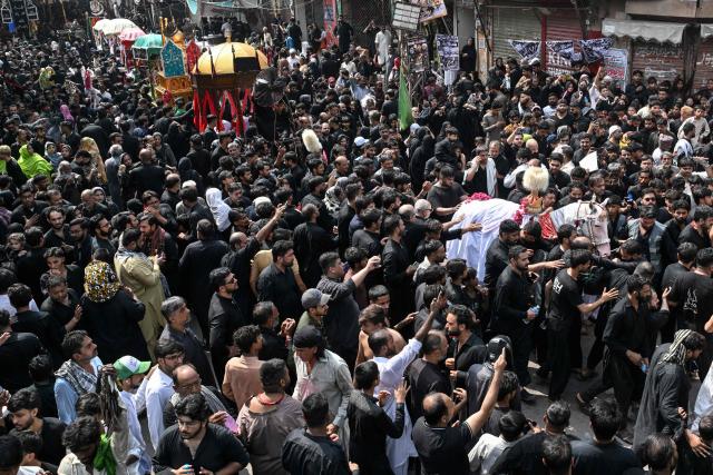 Shia Muslims take part in a religious procession on the ninth day of the Islamic holy month of Muharram in Lahore on June 25, 2026. (Photo by Arif ALI / AFP)