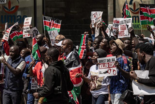 Protesters hold placards and chant anti-government slogans as they march during demonstrations marking the second anniversary of the deadly June 2024 youth-led anti-Finance Bill protests, which saw demonstrators storm Parliament, in Nairobi on June 25, 2026. Kenyan police put on a massive show of force on June 25 in a bid to prevent protests marking two years since a landmark Gen Z uprising. Thousands of Kenyans took to the streets in June 2024 against economic hardship and corruption, eventually storming parliament to force the cancellation of new taxes. (Photo by SIMON MAINA / AFP)