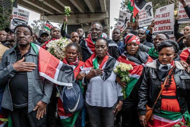 Kenyan veteran opposition leaders James Orengo (L), Martha Karua (C-R) and David Maraga (C-L) sing the Kenyan national anthem alongside families of victims of past protests during demonstrations marking the second anniversary of the deadly June 2024 youth-led anti-Finance Bill protests, which saw demonstrators storm Parliament, in Nairobi on June 25, 2026. Kenyan police put on a massive show of force on June 25 in a bid to prevent protests marking two years since a landmark Gen Z uprising. Thousands of Kenyans took to the streets in June 2024 against economic hardship and corruption, eventually storming parliament to force the cancellation of new taxes. (Photo by Luis TATO / AFP)