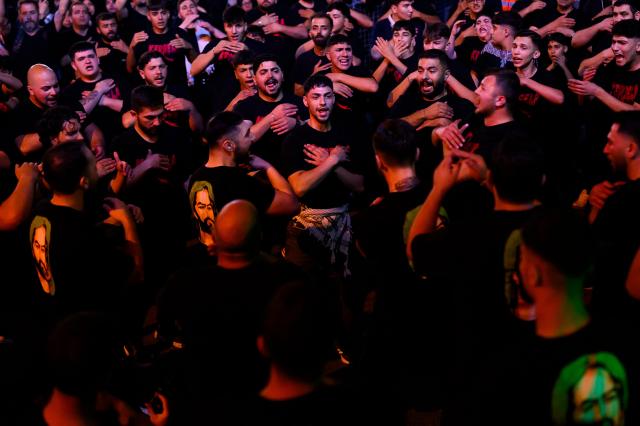 Shiite Muslims take part in the Ashura mourning ritual, which commemorates the killing of the Prophet Muhammad's grandson, Imam Hussein, in the Battle of Karbala in the seventh century, in Istanbul on June 25, 2026. (Photo by Yasin AKGUL / AFP)