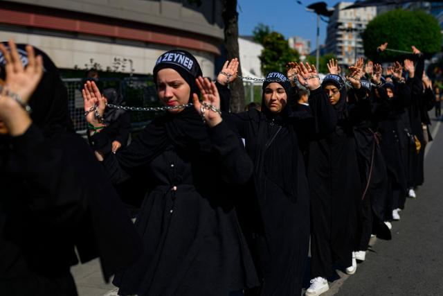 Shiite Muslims take part in the Ashura mourning ritual, which commemorates the killing of the Prophet Muhammad's grandson, Imam Hussein, in the Battle of Karbala in the seventh century, in Istanbul on June 25, 2026. (Photo by Yasin AKGUL / AFP)