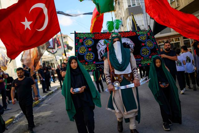 Shiite Muslims take part in the Ashura mourning ritual, which commemorates the killing of the Prophet Muhammad's grandson, Imam Hussein, in the Battle of Karbala in the seventh century, in Istanbul on June 25, 2026. (Photo by Yasin AKGUL / AFP)