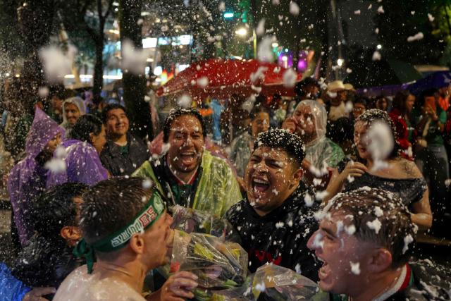 Mexican football fans celebrate their victory at the Angel de la Independencia in Mexico City on June 24, 2026, after the 2026 FIFA World Cup football match between Mexico and Czechia. (Photo by Claudia Rosel / AFP)