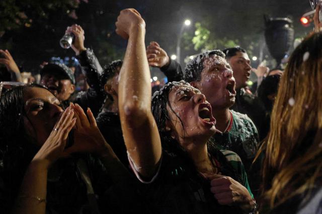 Mexican football fans celebrate their victory at the Angel de la Independencia in Mexico City on June 24, 2026, after the 2026 FIFA World Cup football match between Mexico and Czechia. (Photo by Claudia Rosel / AFP)