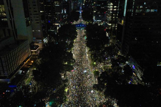 In this aerial view Mexican football fans celebrate their victory at the Angel de la Independencia in Mexico City on June 24, 2026, after the 2026 FIFA World Cup football match between Mexico and Czechia. (Photo by Claudia Rosel / AFP)