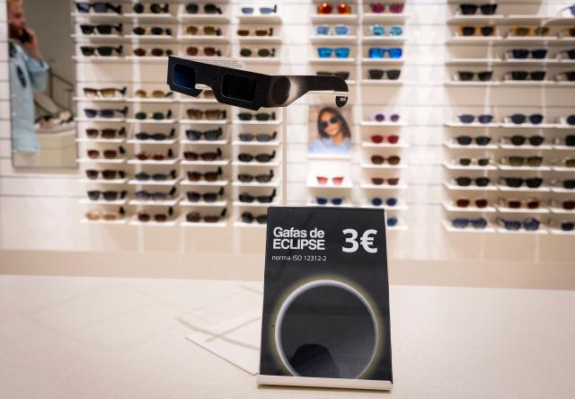 Eclipse viewing glasses certified with the ISO 12312-2:2015 international safety standard which specifies requirements for direct observation of the sun, are displayed at an optician's shop in Palma de Mallorca on June 25, 2026. According to Spain's National Astronomical Observatory, during the evening of Wednesday, August 12, 2026, a total solar eclipse will be visible from the Iberian Peninsula, marking the first such event in over a century. The path of totality of this eclipse will cross Spain from west to east and will pass throught numerous provincial capitals from La Coruna to Palma including Oviedo, Leon, Bilbao, Zaragoza, and Valencia. (Photo by Jaime REINA / AFP)