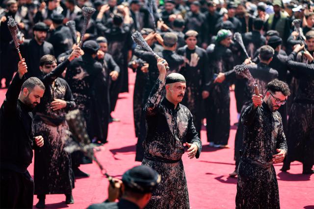 EDITORS NOTE: Graphic content / Shia Muslim devotees self-flagellate during a mourning procession near the Shrine of Imam Abbas in Iraq's holy city of Karbala on June 25, 2026 at the peak of Ashura, a 10-day period commemorating the seventh century killing of Prophet Mohammed's grandson Imam Hussein. (Photo by AHMAD AL-RUBAYE / AFP)
