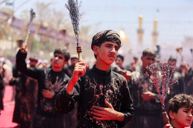 EDITORS NOTE: Graphic content / Shia Muslim devotees self-flagellate during a mourning procession near the Shrine of Imam Abbas in Iraq's holy city of Karbala on June 25, 2026 at the peak of Ashura, a 10-day period commemorating the seventh century killing of Prophet Mohammed's grandson Imam Hussein. (Photo by AHMAD AL-RUBAYE / AFP)