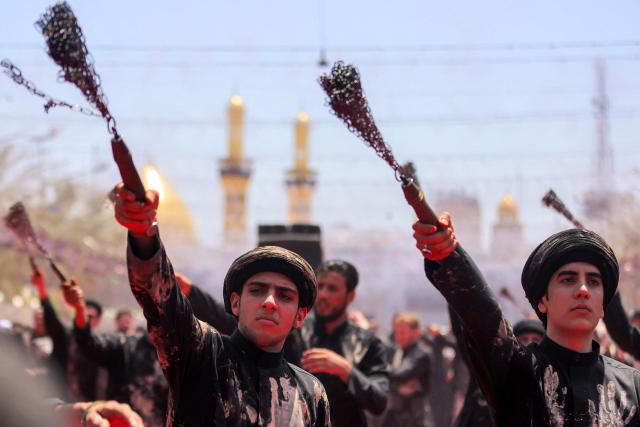 EDITORS NOTE: Graphic content / Shia Muslim devotees self-flagellate during a mourning procession near the Shrine of Imam Abbas in Iraq's holy city of Karbala on June 25, 2026 at the peak of Ashura, a 10-day period commemorating the seventh century killing of Prophet Mohammed's grandson Imam Hussein. (Photo by AHMAD AL-RUBAYE / AFP)
