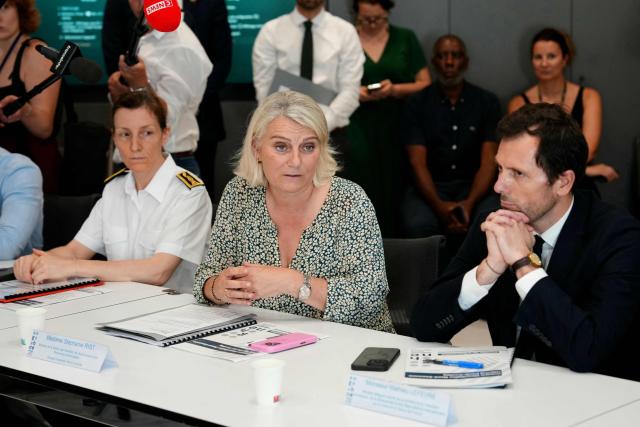 France's Health Minister Stephanie Rist (C) speaks next to Prefect of the Essonne department Fabienne Balussou (2ndL) and Frances junior Minister in charge of the environment Mathieu Lefevre (R) during a visit at the Paris-Saclay hospital in Orsay, southwest of Paris, on June 25, 2026 as a heatwave hits France. In Paris, 25 cardiac arrests were recorded "in twenty-four hours" on June 24, 2026, compared with "fewer than 10 usually," the office of France's Health Minister said on June 25, 2026. (Photo by Dimitar DILKOFF / AFP)