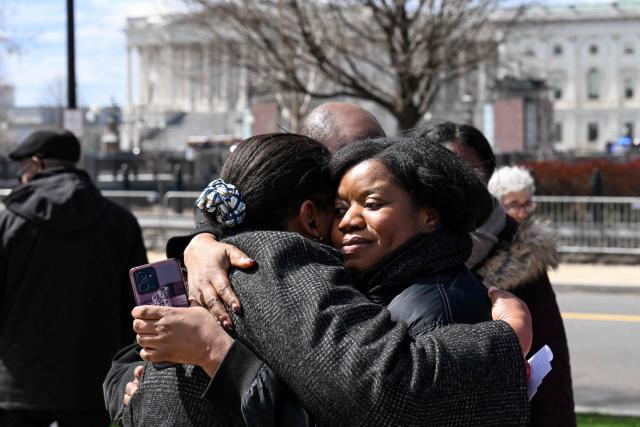 (FILES) Two Haitian human rights activists embrace outside the US Supreme Court in Washington, DC, on March 17, 2026. The US Supreme Court on June 25, 2026, backed a Trump administration move to strip deportation protections from some 350,000 Haitians in the United States and 6,000 Syrians. The conservative-dominated court, in a 6-3 decision, said the Department of Homeland Security's decision to end Temporary Protected Status (TPS) for the Haitian and Syrian immigrants was not subject to judicial review. (Photo by ROBERTO SCHMIDT / AFP)