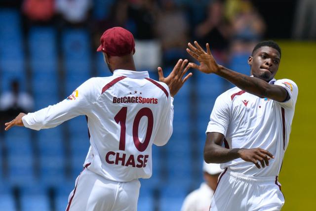 Alzarri Joseph (R) of West Indies celebrates the dismissal of Kamindu Mendis of Sri Lanka during during the first Test cricket match between West Indies and Sri Lanka at Sir Vivian Richards Stadium in North Sound, Antigua and Barbuda, on June 25, 2026. (Photo by Randy Brooks / AFP)