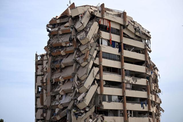 A view shows a heavily damaged apartment building following an earthquake in Catia La Mar, La Guaira state, about 30 km northwest of Caracas, on June 25, 2026. A twin earthquake that was Venezuela's largest in over a century has killed at least 164 people and destroyed multiple buildings near the capital, where residents searched on June 25 for missing relatives. (Photo by Juan BARRETO / AFP)