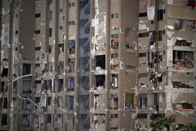 A view shows a heavily damaged apartment building following an earthquake in Catia La Mar, La Guaira state, about 30 km northwest of Caracas, on June 25, 2026. A twin earthquake that was Venezuela's largest in over a century has killed at least 164 people and destroyed multiple buildings near the capital, where residents searched on June 25 for missing relatives. (Photo by Juan BARRETO / AFP)