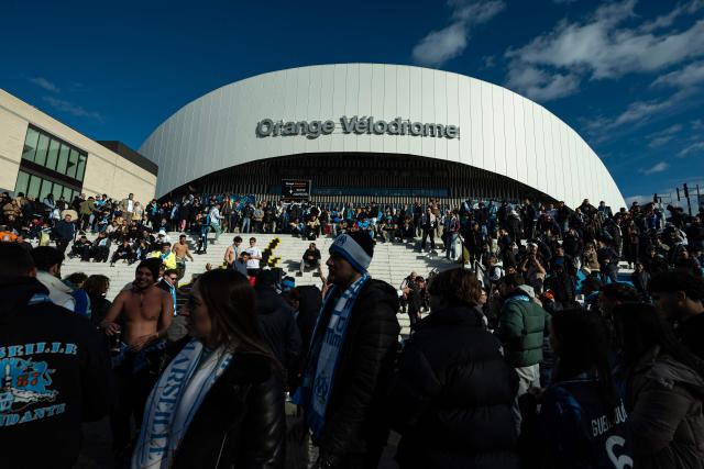 (FILES) Marseille supporters walk outside the stadium prior to the French L1 football match between Olympique de Marseille (OM) and FC Nantes at the Stade Velodrome in Marseille, southern France on January 4, 2026. Olympique de Marseille and CEPAC Bank announced in a joint statement on June 25, 2026 that they have signed a seven-year naming-rights contract under which the Stade Velodrome will become the "CEPAC Velodrome". (Photo by MIGUEL MEDINA / AFP)