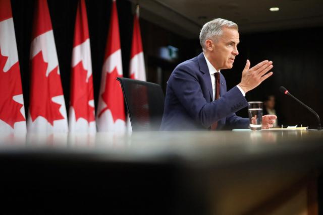 Canadian Prime Minister Mark Carney speaks during a news conference at the National Press Theatre in Ottawa, Canada on June 25, 2026. Carney is holding a wide-ranging news conference to mark last week's end to the parliamentary sitting. (Photo by Dave Chan / AFP)