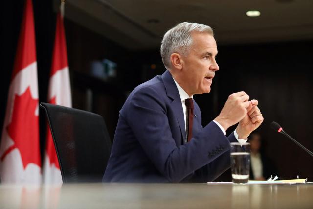 Canadian Prime Minister Mark Carney speaks during a news conference at the National Press Theatre in Ottawa, Canada on June 25, 2026. Carney is holding a wide-ranging news conference to mark last week's end to the parliamentary sitting. (Photo by Dave Chan / AFP)