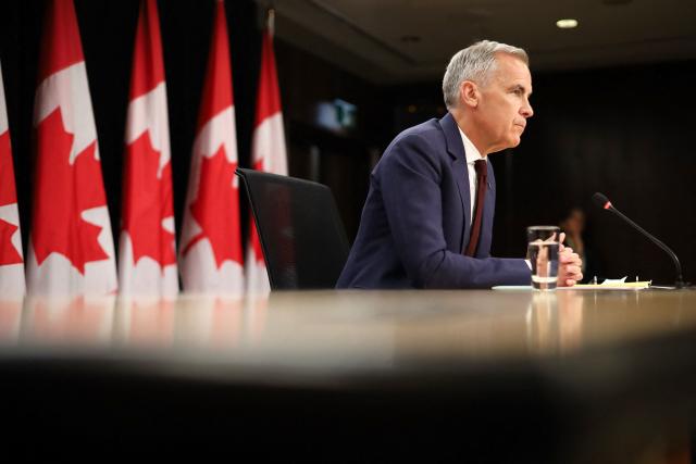 Canadian Prime Minister Mark Carney speaks during a news conference at the National Press Theatre in Ottawa, Canada on June 25, 2026. Carney is holding a wide-ranging news conference to mark last week's end to the parliamentary sitting. (Photo by Dave Chan / AFP)