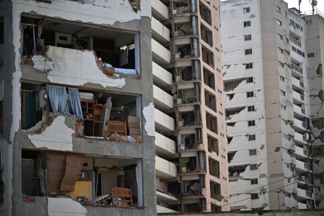 A view shows heavily damaged apartment buildings following an earthquake in Catia La Mar, La Guaira state, about 30 km northwest of Caracas, on June 25, 2026. A twin earthquake that was Venezuela's largest in over a century has killed at least 164 people and destroyed multiple buildings near the capital, where residents searched on June 25 for missing relatives. (Photo by Juan BARRETO / AFP)