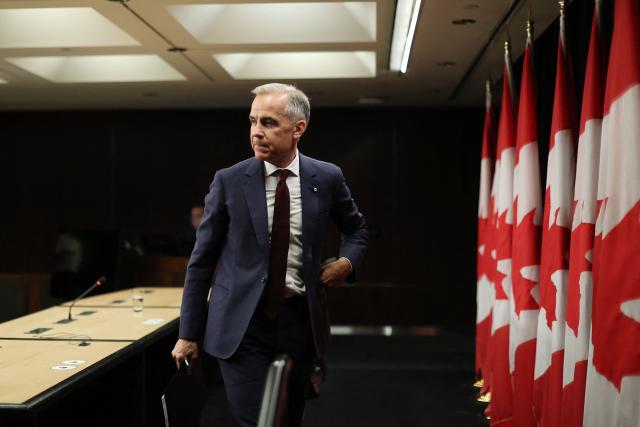 Canadian Prime Minister Mark Carney departs after speaking during a news conference at the National Press Theatre in Ottawa, Canada on June 25, 2026. Carney held a wide-ranging news conference to mark last week's end to the parliamentary sitting. (Photo by Dave Chan / AFP)