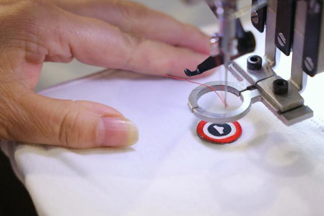 (FILES) An employee sews 'Le Slip Francais' logo at the Bonne Nouvelle textile factory in Aubervilliers, surburb of Paris, on February 12, 2025. The underwear brand Le Slip français, one of the leaders of the "made in France" movement, announced on June 25, 2026 that it will go public on the symbolic date of July 14, hoping to raise 5 million euros in fresh capital. (Photo by Thomas SAMSON / AFP)