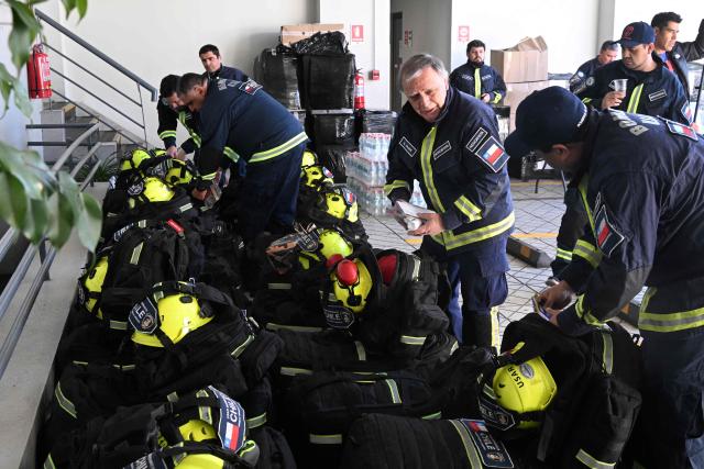 Chile's USAR search and rescue team prepares to deploy to Venezuela at the National Firefighters Board headquarters in Santiago on June 25, 2026, after two powerful earthquakes left at least 164 dead and hundreds injured. An international outpouring of aid quickly followed the tremors on June 24 evening, which the United States Geological Survey measured as magnitude 7.2 and 7.5, centered west of the capital Caracas. (Photo by RODRIGO ARANGUA / AFP)