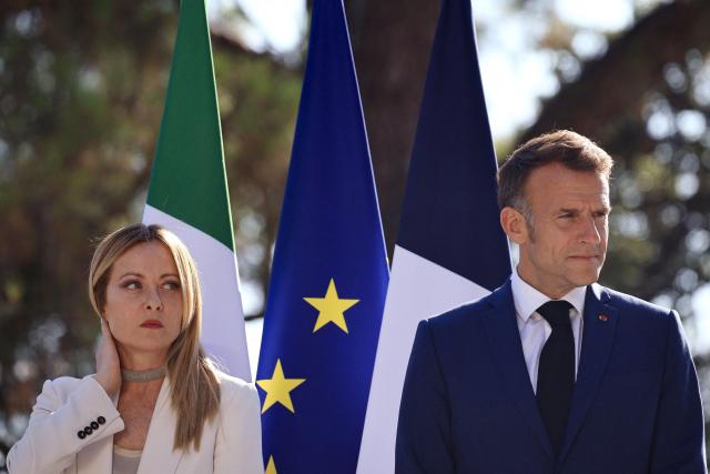 Italy's Prime Minister Giorgia Meloni (L) and France's President Emmanuel Macron (R) react during an agreement signing ceremony as part of a Franco-Italian summit in Antibes, French Riviera, southern France on June 25, 2026. The talks mark the first Franco-Italian summit since a treaty on a strategic alliance came into force in 2021, elevating relations to a level comparable to that between France and Germany. (Photo by Manon Cruz / POOL / AFP)