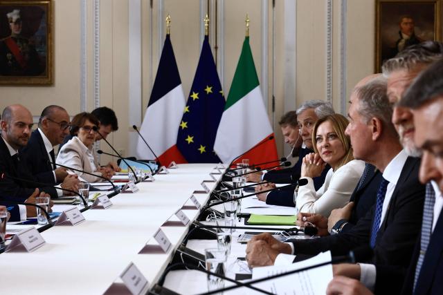Italy's Prime Minister Giorgia Meloni (C-R) and France's President Emmanuel Macron (unseen) and members of their respective delegations attend an agreement signing ceremony as part of a Franco-Italian summit in Antibes, French Riviera, southern France on June 25, 2026. The talks mark the first Franco-Italian summit since a treaty on a strategic alliance came into force in 2021, elevating relations to a level comparable to that between France and Germany. (Photo by Manon Cruz / POOL / AFP)