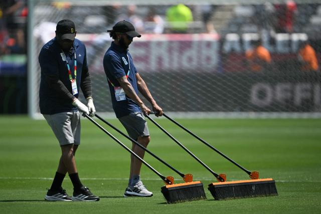Groundstaff brush the pitch ahead of the 2026 World Cup football tournament Group E football match between Ecuador and Germany at New York/New Jersey Stadium in East Rutherford on June 25, 2026. (Photo by MAURO PIMENTEL / AFP)