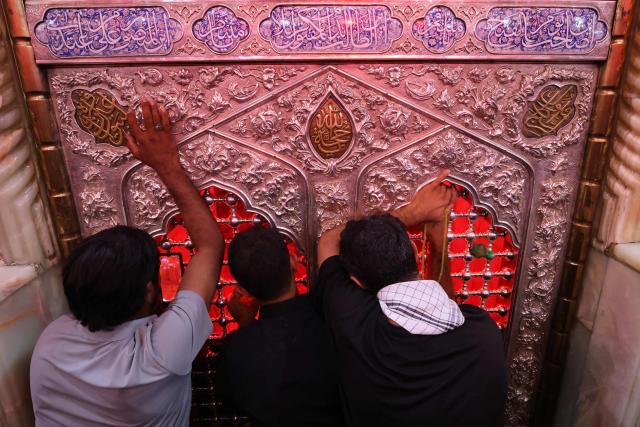 Shia Muslim devotees gather at the grave of Imam Hussein for a mourning ritual in Iraq's holy city of Karbala on June 25, 2026, at the peak of Ashura, a 10-day period commemorating the seventh century killing of Prophet Mohammed's grandson Imam Hussein. (Photo by AHMAD AL-RUBAYE / AFP)