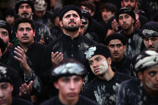 Shia Muslim devotees take part in a mourning procession in Iraq's holy city of Karbala on June 25, 2026, at the peak of Ashura, a 10-day period commemorating the seventh century killing of Prophet Mohammed's grandson Imam Hussein. (Photo by AHMAD AL-RUBAYE / AFP)