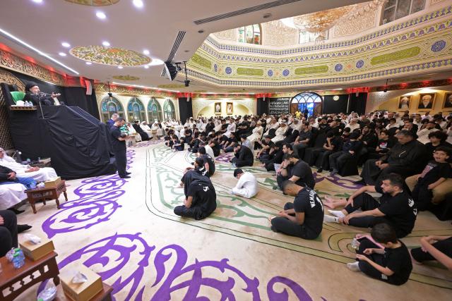 Shiite Muslim devotees attend a ceremony to commemorate Ashura at the Al-Awhad Husseiniya, in Kuwait City on June 25, 2026. The commemoration of Ashura consists of a ten-day mourning period starting on the first day of Muharram according to the Islamic calendar, marking the seventh-century slaying of Prophet Mohammed's grandson Imam Hussein. (Photo by YASSER AL-ZAYYAT / AFP)