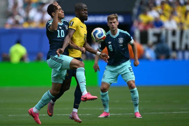 Germany's midfielder #10 Jamal Musiala and Ecuador's forward #13 Enner Valencia fight for the ball during the 2026 World Cup Group E football match between Ecuador and Germany at the New York/New Jersey Stadium in East Rutherford on June 25, 2026. (Photo by MAURO PIMENTEL / AFP)