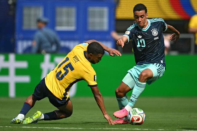 Ecuador's midfielder #15 Pedro Vite and Germany's midfielder #10 Jamal Musiala fight for the ball during the 2026 World Cup Group E football match between Ecuador and Germany at the New York/New Jersey Stadium in East Rutherford on June 25, 2026. (Photo by MAURO PIMENTEL / AFP)