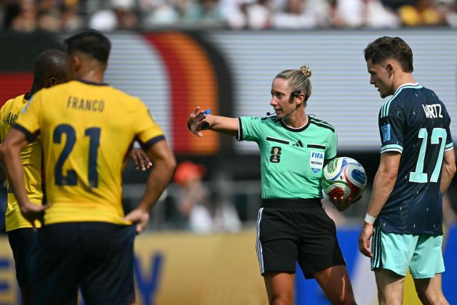US referee Tori Penso gestures next to Germany's midfielder #17 Florian Wirtz during the 2026 World Cup Group E football match between Ecuador and Germany at the New York/New Jersey Stadium in East Rutherford on June 25, 2026. (Photo by MAURO PIMENTEL / AFP)