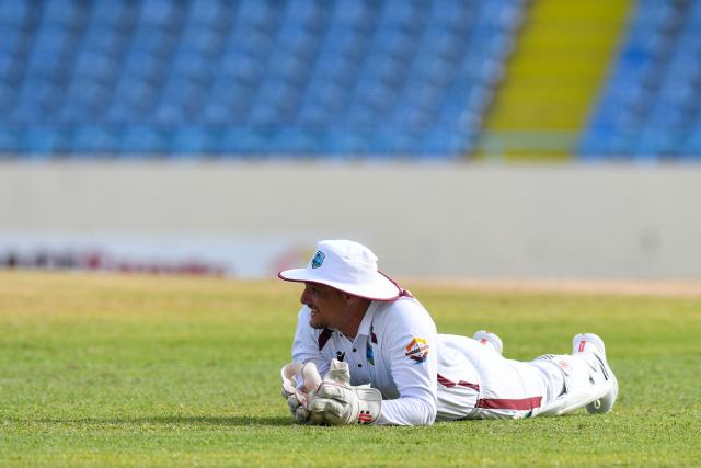 Joshua Da Silva of West Indies lies down after dropping Milan Rathnayake of Sri Lanka  during the first day of the first Test cricket match between West Indies and Sri Lanka at Sir Vivian Richards Stadium in North Sound, Antigua and Barbuda, on June 25, 2026. (Photo by Randy Brooks / AFP)